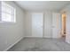 Bedroom with carpeted floor, white trim and closet with views to the hallway and window at 2290 Pope Rd, Douglasville, GA 30135