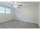 Bright bedroom featuring ceiling fan, window and carpeted floor, offering a comfortable space at 2290 Pope Rd, Douglasville, GA 30135