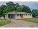 Single-story home boasting a long driveway, carport, a bright red front door and brick facade at 2290 Pope Rd, Douglasville, GA 30135