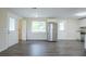 The kitchen area features new wood-look flooring, a stainless steel refrigerator, and easy access to the laundry room at 2290 Pope Rd, Douglasville, GA 30135