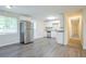 Kitchen with new wood-look floors, stainless refrigerator, and access to additional rooms in the home at 2290 Pope Rd, Douglasville, GA 30135