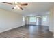 Open-concept living room with wood-look flooring, a stainless steel refrigerator and updated paint at 2290 Pope Rd, Douglasville, GA 30135