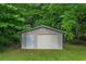 Exterior shot of the storage shed with a white door and garage door at 2290 Pope Rd, Douglasville, GA 30135