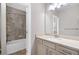 Bathroom with vanity and shower over bath with decorative tile surround at 2499 Barrett Preserve Sw Ct, Marietta, GA 30064