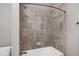 Bathroom with shower over bath with decorative tile surround at 2499 Barrett Preserve Sw Ct, Marietta, GA 30064