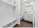 Stylish mudroom includes bench seating and a view into an adjacent half bath at 2499 Barrett Preserve Sw Ct, Marietta, GA 30064