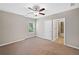 Bedroom with neutral carpet, fan and access to ensuite bathroom at 2499 Barrett Preserve Sw Ct, Marietta, GA 30064