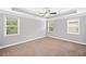 A spacious bedroom featuring neutral colors, tray ceiling, and ample natural light at 2499 Barrett Preserve Sw Ct, Marietta, GA 30064