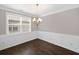 Elegant dining room featuring wainscoting details, a chandelier, and hardwood flooring at 2499 Barrett Preserve Sw Ct, Marietta, GA 30064
