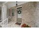 Cozy entryway with brick wall, decorative wreath, and a 'Welcome' mat at 2499 Barrett Preserve Sw Ct, Marietta, GA 30064
