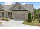 Attractive townhome showing a well-manicured lawn and an attached two-car garage at 2499 Barrett Preserve Sw Ct, Marietta, GA 30064