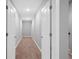 Hallway with neutral walls and carpet, recessed lighting, and white doors at 2499 Barrett Preserve Sw Ct, Marietta, GA 30064
