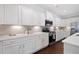 Modern kitchen with white cabinets, stone countertops, and stainless steel appliances at 2499 Barrett Preserve Sw Ct, Marietta, GA 30064