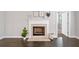 Inviting living room with a classic fireplace, neutral paint, and dark hardwood floors at 2499 Barrett Preserve Sw Ct, Marietta, GA 30064