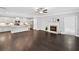 A spacious living room, with hardwood floors, fireplace, and open access to the kitchen at 2499 Barrett Preserve Sw Ct, Marietta, GA 30064