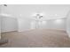 Spacious living room features neutral walls, plush carpet, and modern ceiling fan at 2499 Barrett Preserve Sw Ct, Marietta, GA 30064