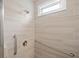 Modern shower stall with tiled walls, a showerhead, and convenient grab bars at 2499 Barrett Preserve Sw Ct, Marietta, GA 30064