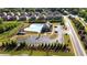 Aerial view of a community pool, clubhouse, parking and homes in a Primary planned neighborhood at 2692 Pearl Ridge Trce, Buford, GA 30519