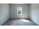 Carpeted bedroom with large window offering natural light at 2692 Pearl Ridge Trce, Buford, GA 30519