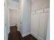 Hallway with coat hooks, leading to half-bathroom with clean, modern design at 2692 Pearl Ridge Trce, Buford, GA 30519