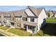 Beautifully landscaped townhome exterior showcasing a well-manicured lawn and cozy front porch at 2692 Pearl Ridge Trce, Buford, GA 30519