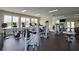 Bright community fitness center featuring modern cardio equipment and weight machines with mirrors at 2692 Pearl Ridge Trce, Buford, GA 30519