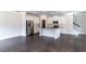 Open-concept living room and kitchen with white cabinets, stainless steel appliances, and hardwood floors at 2692 Pearl Ridge Trce, Buford, GA 30519