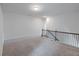 Open loft area featuring plush carpeting and an ornamental metal railing at 2692 Pearl Ridge Trce, Buford, GA 30519