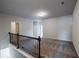 Upstairs loft area with neutral carpet and a view of the lower level at 2692 Pearl Ridge Trce, Buford, GA 30519