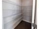 Walk-in pantry with wire shelving and dark floors, providing ample storage space for food and supplies at 2692 Pearl Ridge Trce, Buford, GA 30519