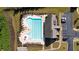 Aerial view of community pool with chairs, trees, and a nearby parking lot on a sunny day at 2692 Pearl Ridge Trce, Buford, GA 30519
