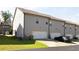 Townhome rear exterior with garages, driveway parking, and small yard at 2692 Pearl Ridge Trce, Buford, GA 30519