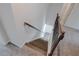 Staircase with wooden steps and a decorative metal railing at 2692 Pearl Ridge Trce, Buford, GA 30519