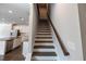 Carpeted stairs with a wooden handrail leading to the upper level at 2692 Pearl Ridge Trce, Buford, GA 30519