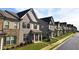 Attractive townhomes lined up on a street in a modern residential neighborhood at 2692 Pearl Ridge Trce, Buford, GA 30519