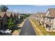 Long street view of identical townhomes in a new residential neighborhood at 2692 Pearl Ridge Trce, Buford, GA 30519