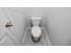 Compact toilet in a modern bathroom with gray tile flooring at 2692 Pearl Ridge Trce, Buford, GA 30519