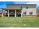 Spacious backyard featuring a covered patio with outdoor seating and a grill at 320 Conley Ave, Hampton, GA 30228