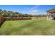 Expansive backyard featuring a well-maintained lawn, privacy fence, and view of the surrounding trees at 320 Conley Ave, Hampton, GA 30228