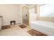 Bright bathroom featuring a glass shower, soaking tub and tile flooring at 320 Conley Ave, Hampton, GA 30228