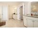 Bright bathroom with tile flooring, granite countertops and white cabinets at 320 Conley Ave, Hampton, GA 30228