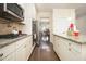 Open kitchen showcasing stainless steel appliances, granite countertops, and ample cabinet space at 320 Conley Ave, Hampton, GA 30228