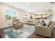 Bright living room featuring modern seating arrangement, and stylish area rug at 320 Conley Ave, Hampton, GA 30228