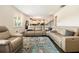 Bright living room featuring modern seating arrangement, and stylish area rug and kitchen at 320 Conley Ave, Hampton, GA 30228