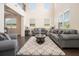 Inviting living room with tall ceilings, large windows, and hardwood floors at 320 Conley Ave, Hampton, GA 30228