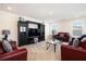 Comfortable living room features a dark cabinet with a TV in the middle with carpet flooring at 320 Conley Ave, Hampton, GA 30228