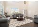 Spacious living room with hardwood floors, neutral tones, and cozy seating at 320 Conley Ave, Hampton, GA 30228