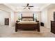 Spacious main bedroom featuring a large bed, tray ceiling and recessed lighting at 320 Conley Ave, Hampton, GA 30228