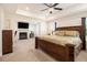 Spacious main bedroom featuring a large bed, fireplace and recessed lighting at 320 Conley Ave, Hampton, GA 30228