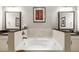 Relaxing bathroom with a large soaking tub, dual vanities, and modern fixtures at 3621 Vinings Slope Se # 1231, Atlanta, GA 30339